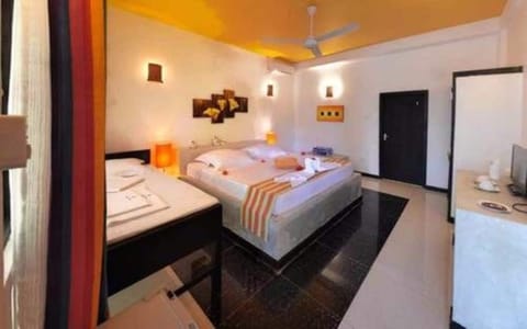 Deluxe Triple Room | Minibar, in-room safe, desk, free WiFi