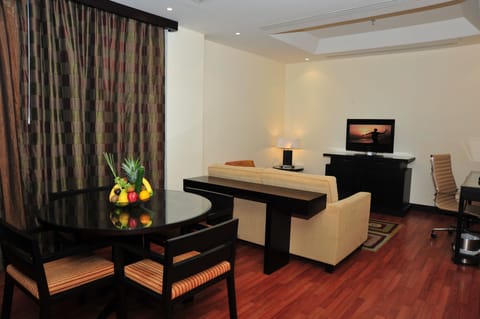 Junior Suite, 1 King Bed (Additional Living Area) | Living room | 32-inch LCD TV with digital channels, TV