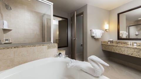 Suite, 1 King Bed (Whirlpool) | Bathroom | Combined shower/tub, free toiletries, hair dryer, towels