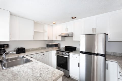 Condo, 2 Bedrooms (Unit 117) | Private kitchen | Full-size fridge, microwave, oven, stovetop