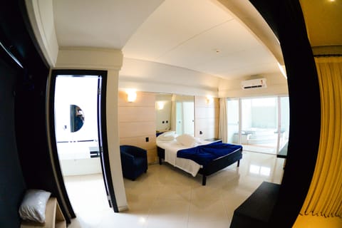 Junior Suite, 1 King Bed | Living room | 39-inch LCD TV with cable channels, TV