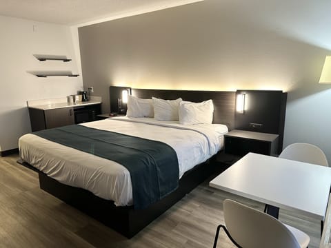 Desk, laptop workspace, blackout drapes, bed sheets