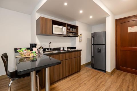 Suite, 2 Double Beds | Private kitchen | Fridge, microwave, stovetop, griddle