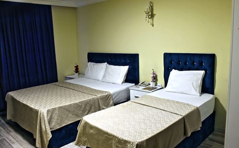 Standard Triple Room | Minibar, in-room safe, iron/ironing board, free WiFi