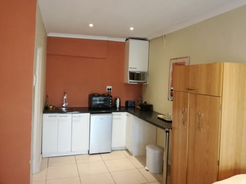 Room, Multiple Beds | Private kitchen | Full-size fridge, microwave, stovetop, coffee/tea maker