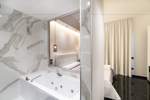 Luxury Suite, 1 King Bed, Private Bathroom, City View | Bathroom | Combined shower/tub, rainfall showerhead, free toiletries, hair dryer