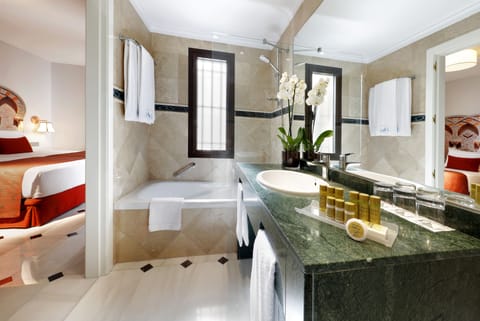 Bathtub, eco-friendly toiletries, hair dryer, towels