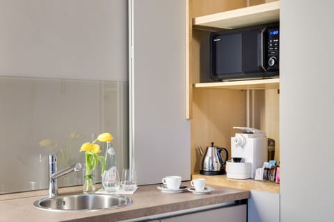 Deluxe Apartment, 1 Queen Bed, Kitchenette, Garden View | Private kitchenette | Fridge, espresso maker, electric kettle, highchair