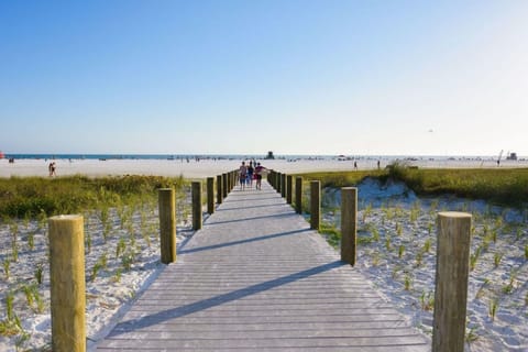 On the beach, white sand, sun loungers, beach towels