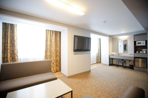 Family Suite (No Parking, additional fee occurs if number of people booked & staying are different) | Living area | LCD TV