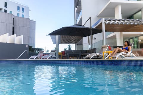 Outdoor pool, open 7:00 AM to 10:00 PM, pool umbrellas, sun loungers