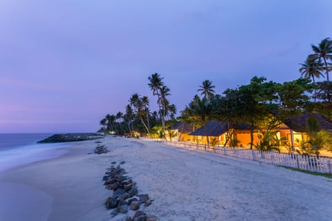 On the beach, white sand, sun loungers, beach umbrellas