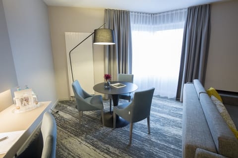 Junior Suite | Living area | 49-inch flat-screen TV with cable channels, TV, tablet