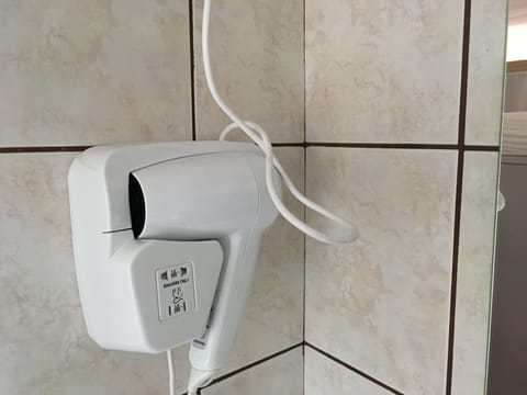 Economy Room (Room 1) | Bathroom | Shower, hair dryer, towels, soap