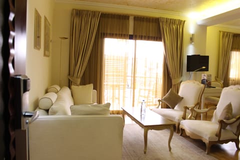 Junior Suite | Living area | 16-inch flat-screen TV with cable channels, TV