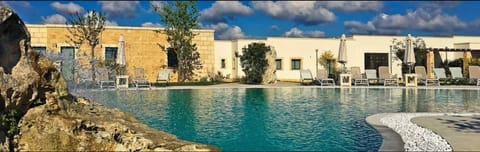 Outdoor pool, a waterfall pool, sun loungers