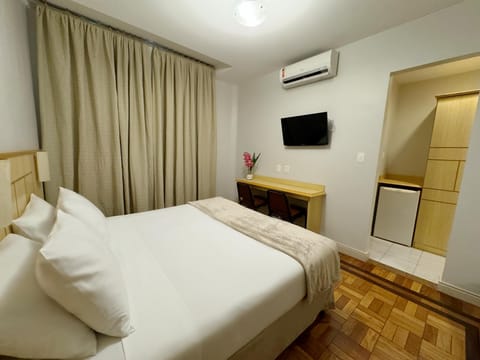 Standard Double Room | Minibar, in-room safe, desk, blackout drapes