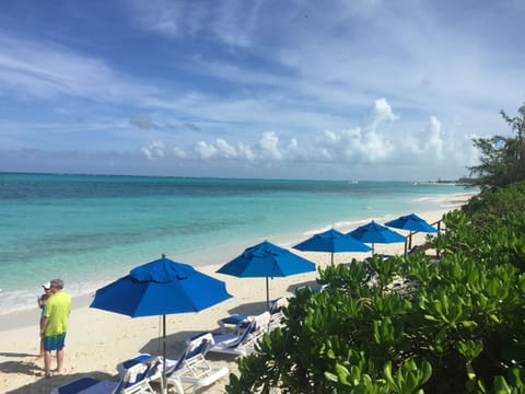 On the beach, white sand, sun loungers, beach umbrellas