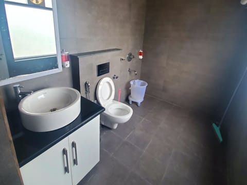 BROWN VILLA WITH A BIG PRIVATE SIT-OUT | Bathroom | Rainfall showerhead, free toiletries, bathrobes, bidet