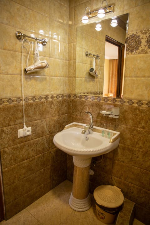 Separate tub and shower, designer toiletries, hair dryer, slippers