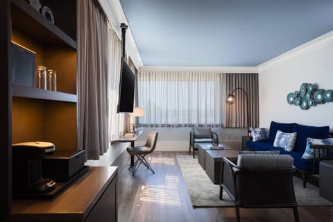 Suite, 1 King Bed | Living area | 55-inch flat-screen TV with digital channels, TV