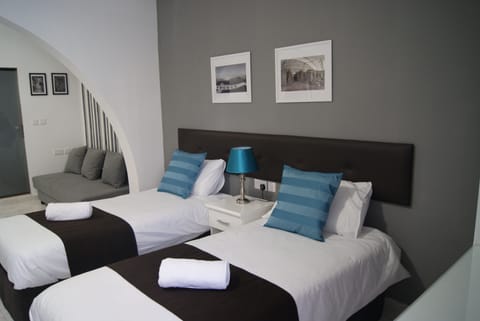 Family Quadruple Room, Multiple Beds | In-room safe, desk, free WiFi, bed sheets