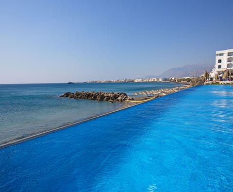 On the beach, sun loungers, beach umbrellas, water skiing