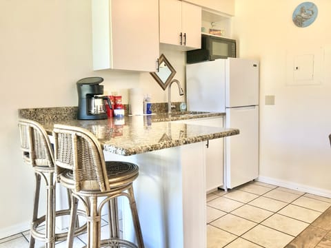 Deluxe King Suite | Private kitchenette | Fridge, microwave, coffee/tea maker, cookware/dishes/utensils