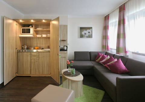 Deluxe Suite, 1 King Bed | Living area | Flat-screen TV, heated floors