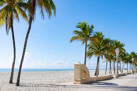 On the beach, white sand, beach cabanas, sun loungers