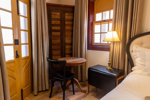 Economy Double Room | Minibar, in-room safe, blackout drapes, iron/ironing board