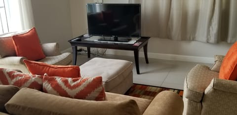 Elite Apartment, 1 Bedroom, Ensuite | Living room | 50-inch flat-screen TV with cable channels, TV, DVD player