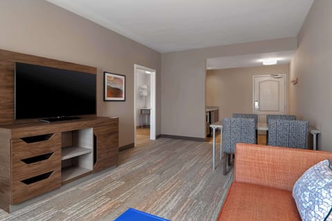 Suite, 1 King Bed, Refrigerator & Microwave (Wet bar) | Living area | 55-inch Smart TV with cable channels, TV