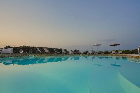 Seasonal outdoor pool, open 8:00 AM to 8:00 PM, pool umbrellas