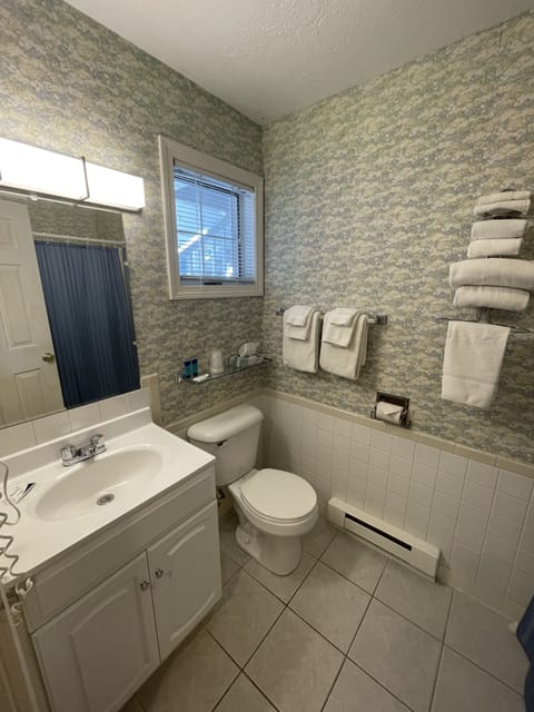 Room, 2 Double Beds | Bathroom | Combined shower/tub, free toiletries, hair dryer, towels