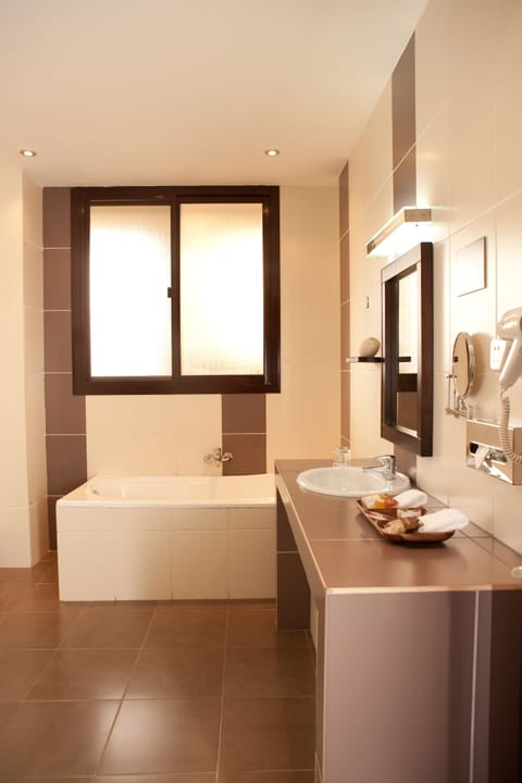 Suite, 1 King Bed, Non Smoking, City View | Bathroom | Designer toiletries, hair dryer, bathrobes, slippers