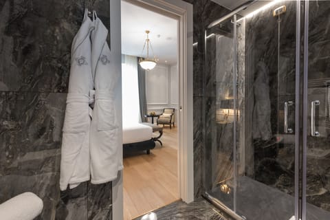 Suite, City View | Bathroom | Rainfall showerhead, designer toiletries, hair dryer, slippers