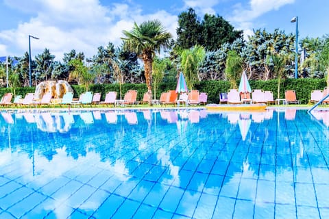 Seasonal outdoor pool, open 9:00 AM to 8:00 PM, pool umbrellas