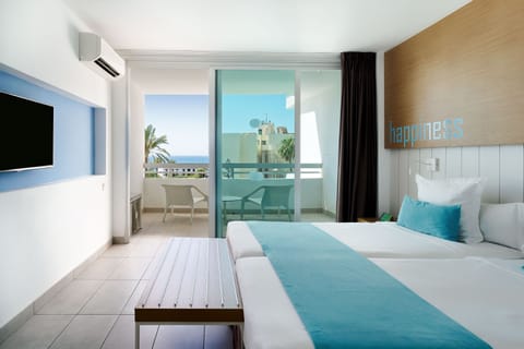 Deluxe Room, Partial Sea View | In-room safe, desk, laptop workspace, blackout drapes