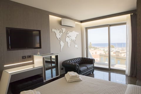 Luxury Suite, Balcony, Sea View | Premium bedding, minibar, in-room safe, desk