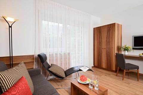 Junior Suite, Patio | Living area | Flat-screen TV