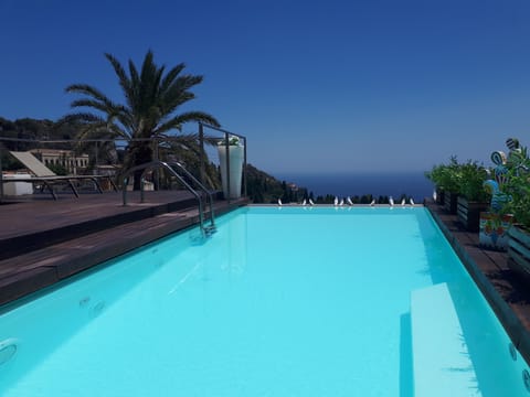 Outdoor pool, open 9 AM to 7 PM, pool umbrellas, sun loungers