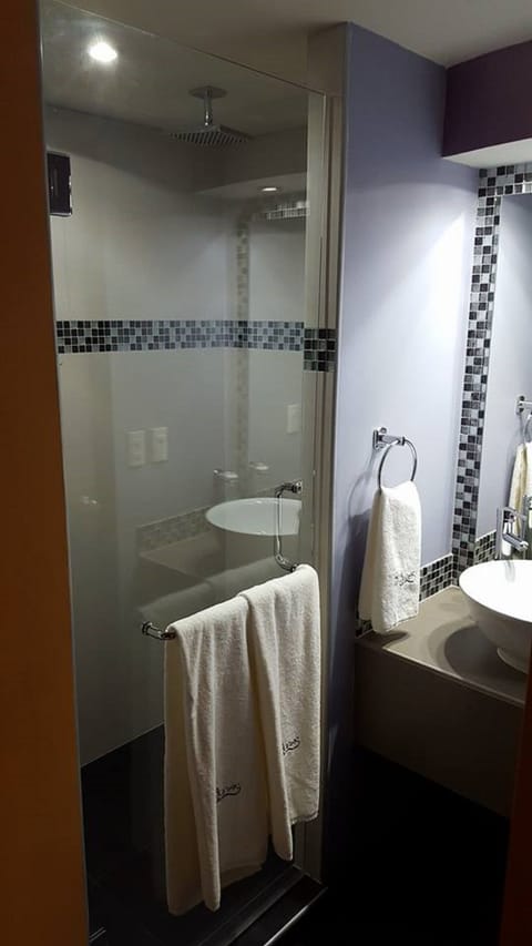 Suite, 1 King Bed | Bathroom | Shower, rainfall showerhead, free toiletries, towels