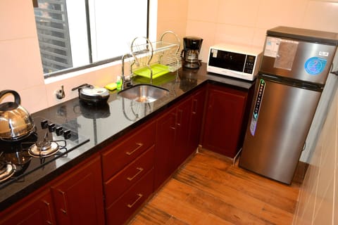 Senior Apartment, Multiple Beds | Private kitchen | Full-size fridge, microwave, oven, stovetop