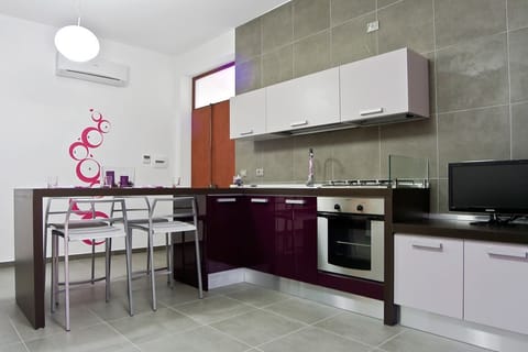 Apartment, 1 Bedroom | Private kitchen | Fridge, stovetop, highchair, cookware/dishes/utensils