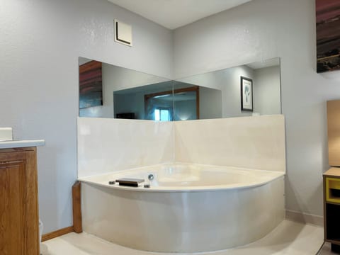 Suite, 1 King Bed, Refrigerator & Microwave | Bathroom | Combined shower/tub, hair dryer, towels