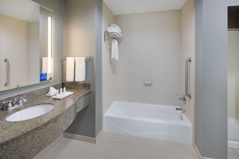 Suite, One King Bed | Bathroom | Combined shower/tub, designer toiletries, hair dryer, towels