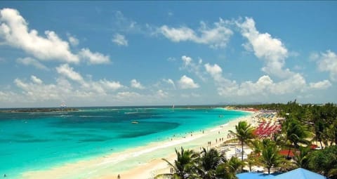 On the beach, white sand, sun loungers, beach umbrellas