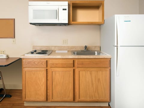 Full-size fridge, microwave, stovetop, dining tables