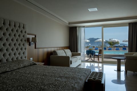 Junior Suite, Pool Access | Minibar, in-room safe, desk, free WiFi